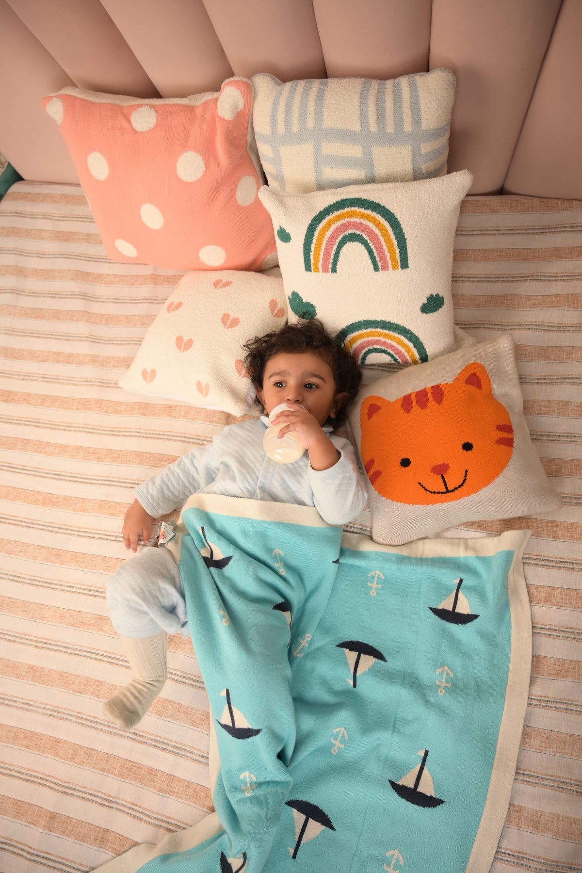 Baby styled with cushions and blanket