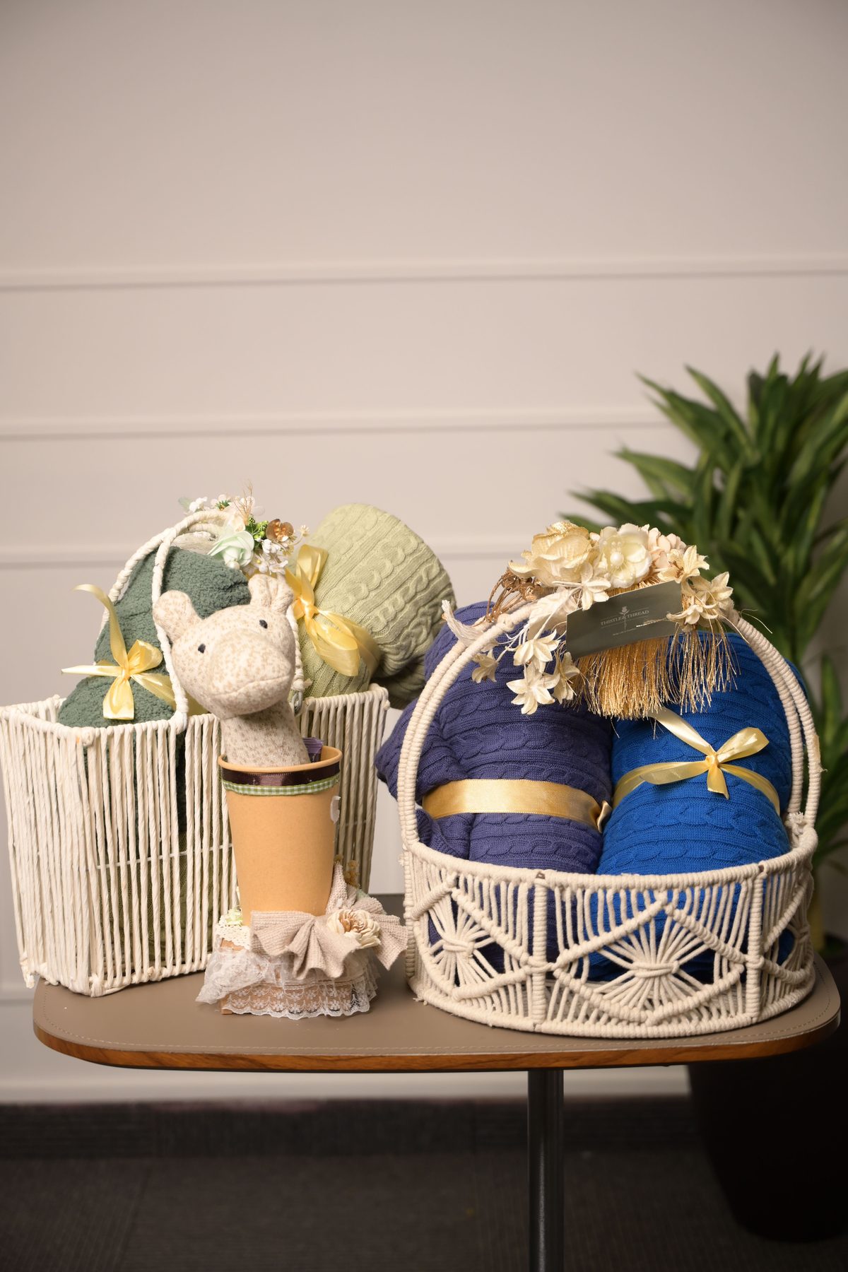 Gift basket styled with throws and a knitted toy