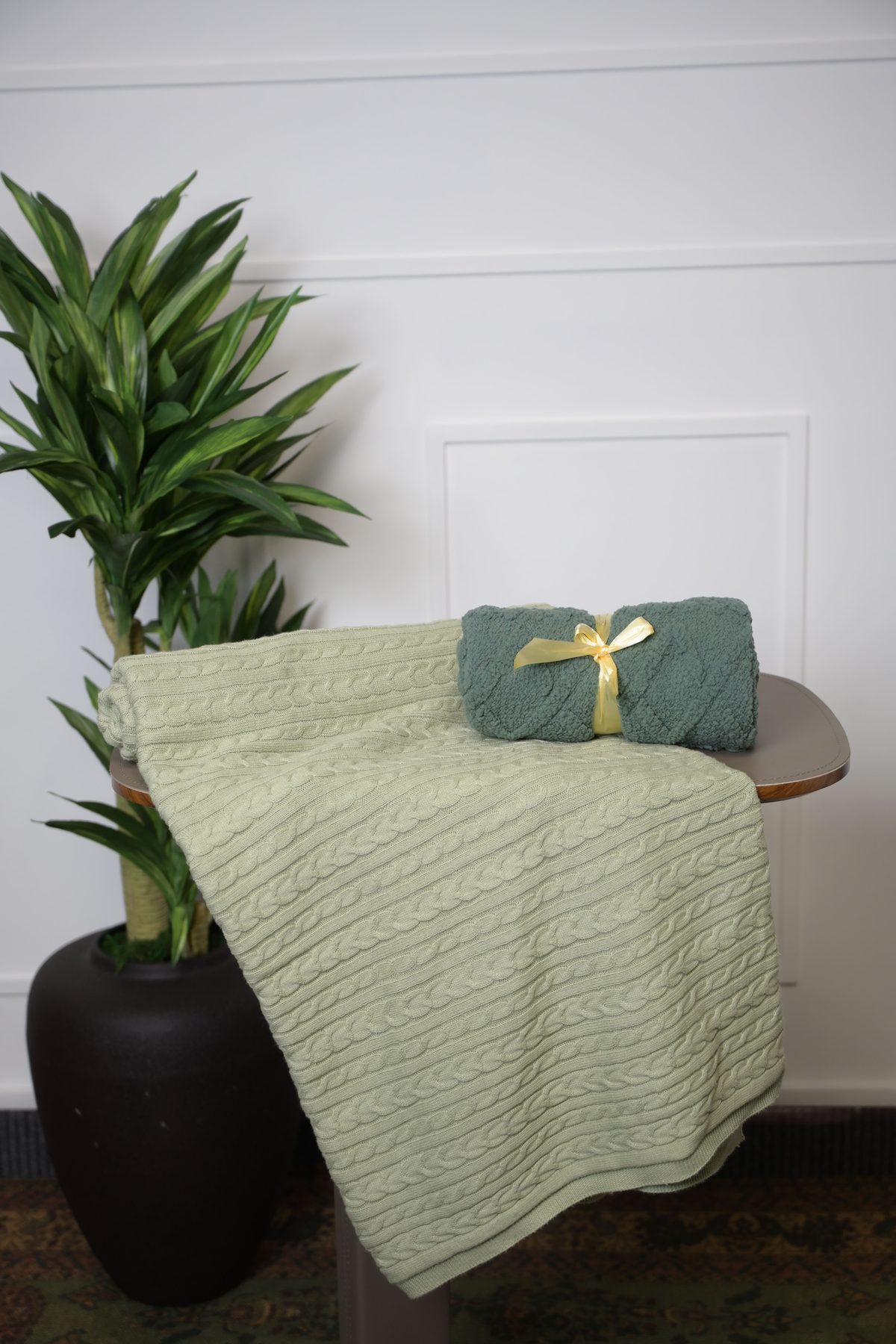 Sage throw draped with a teal throw