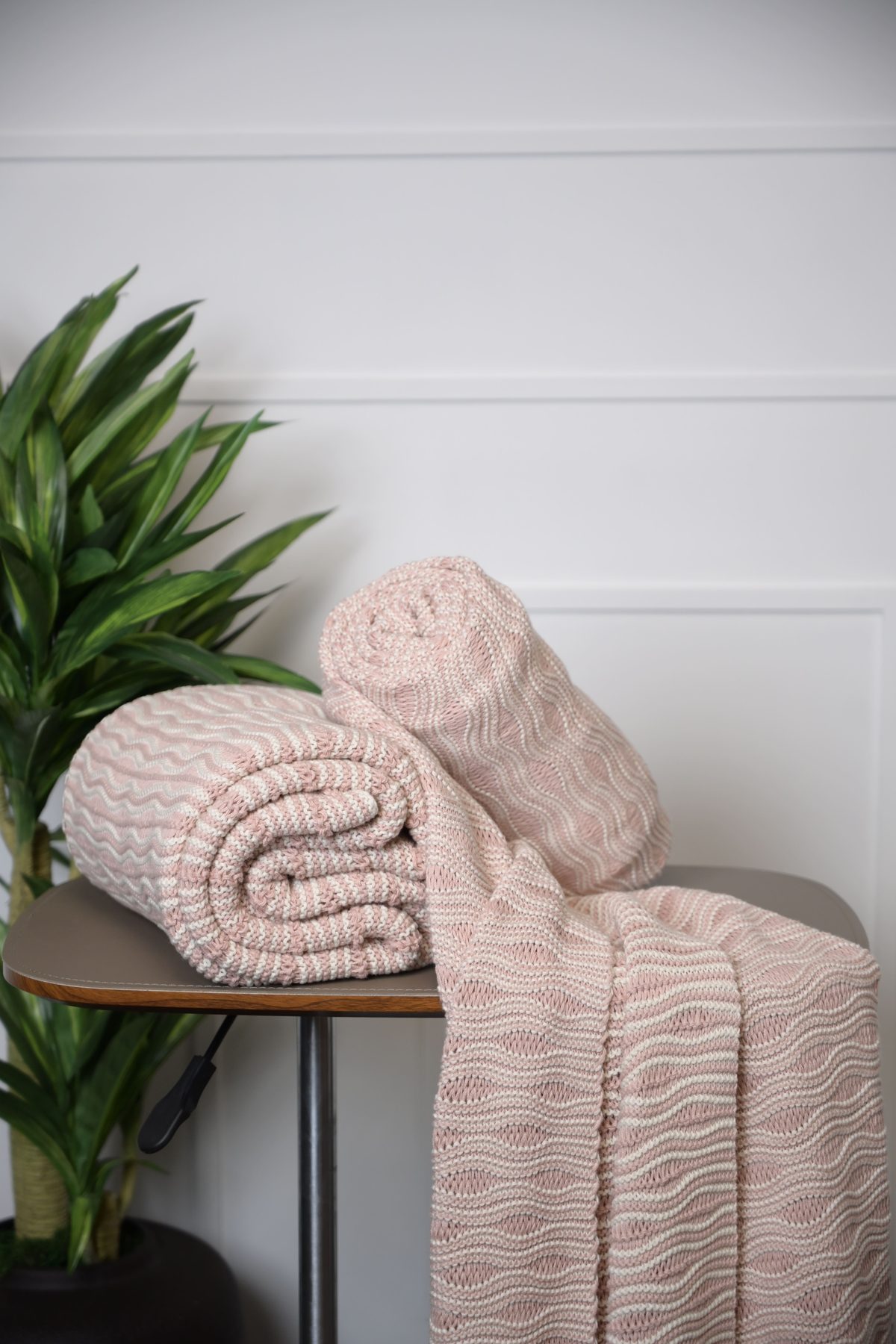 Pink textured throw folded