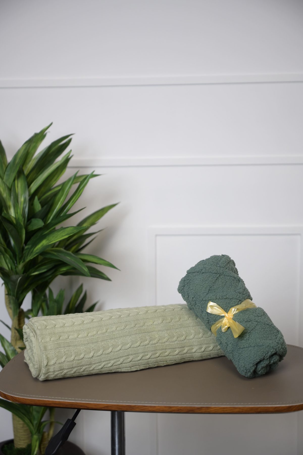 Sage and teal throws rolled together